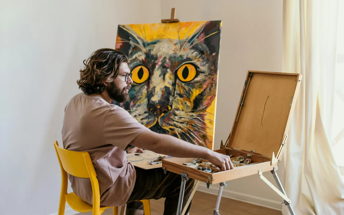 Man painting cat