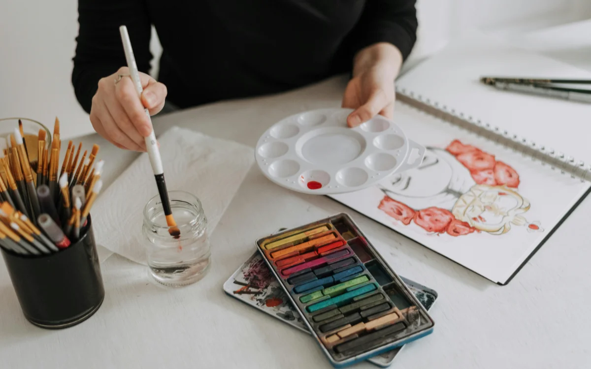 artist painting at table