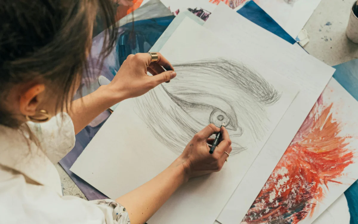 A Woman Drawing while Sitting on the Floor