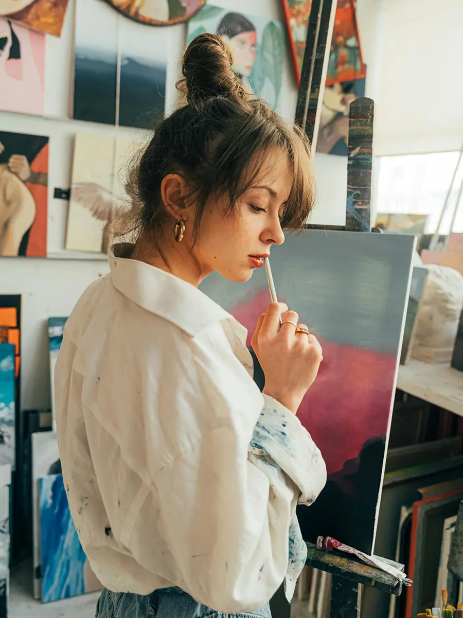 Artist working on a painting in a studio