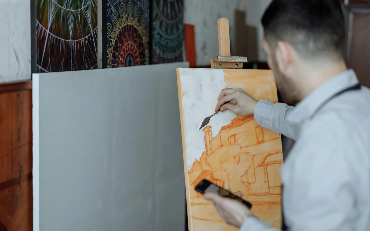 A Man Painting on a Canvas